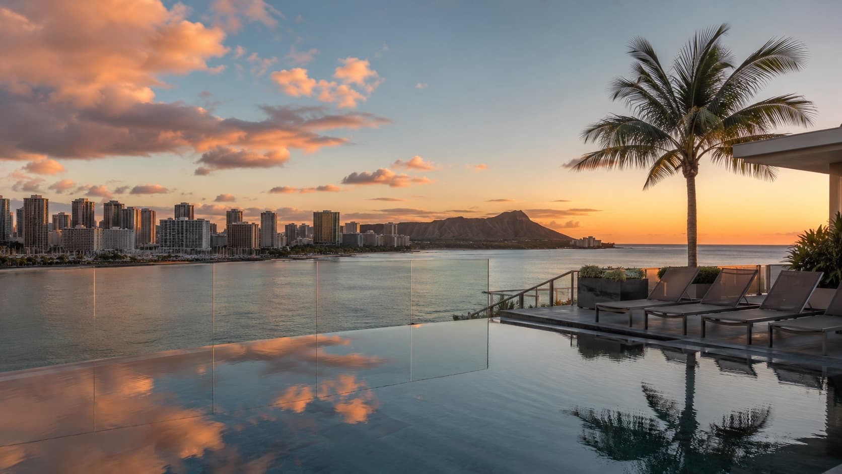 Waikiki pool at golden hour with city skyline